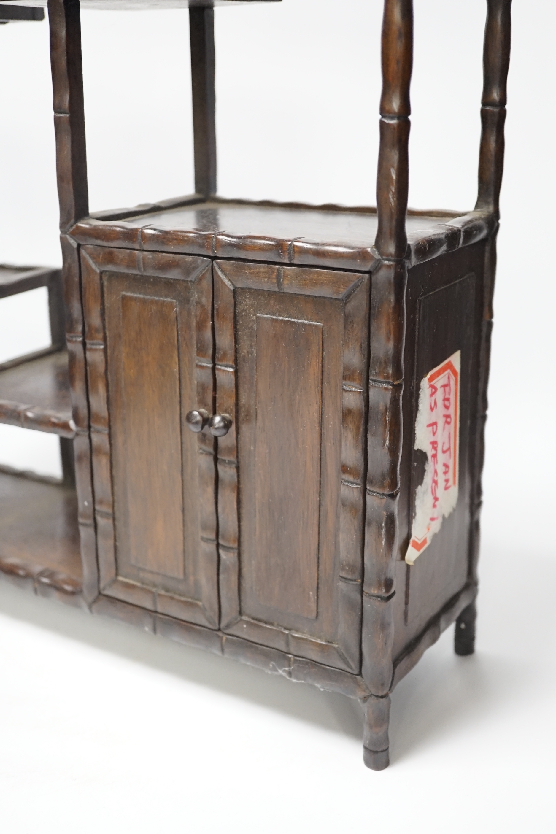 An early 20th century Chinese hongmu display shelf with cupboard and drawer, 46cm high